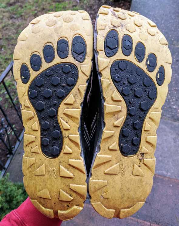 The soles of my Altra Lonepeak 3.0 running shoes, heavily worn down